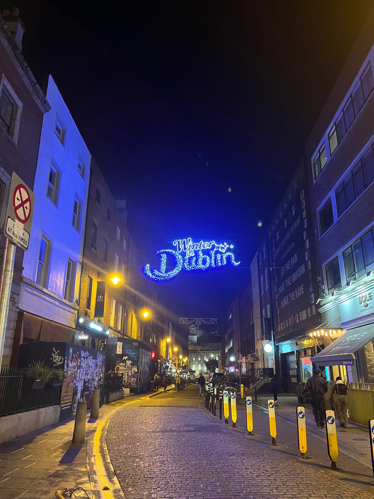 A Dublin city street with a big sign across it that says "Winter in Dublin."